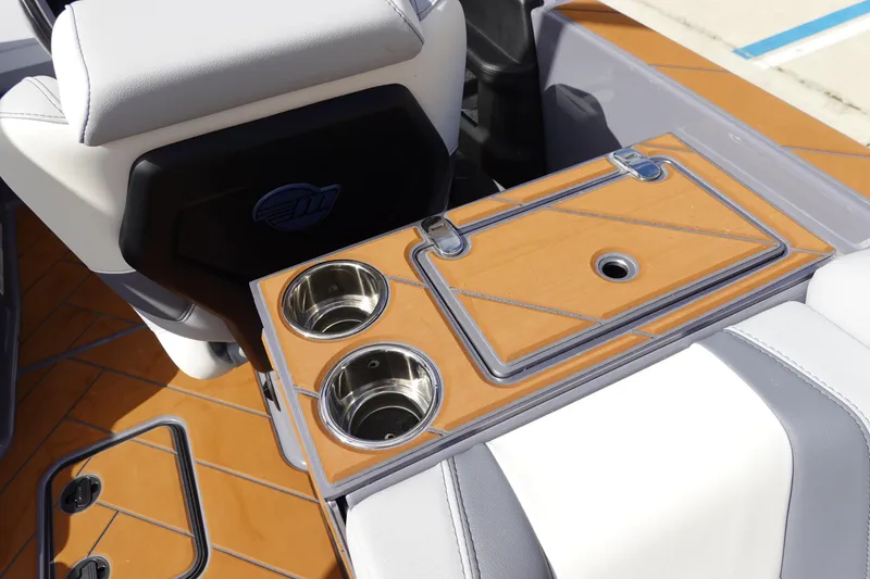 Slide: The Image of 2023 Malibu 25 LSV boat interior with cup holders and storage compartment. - 21