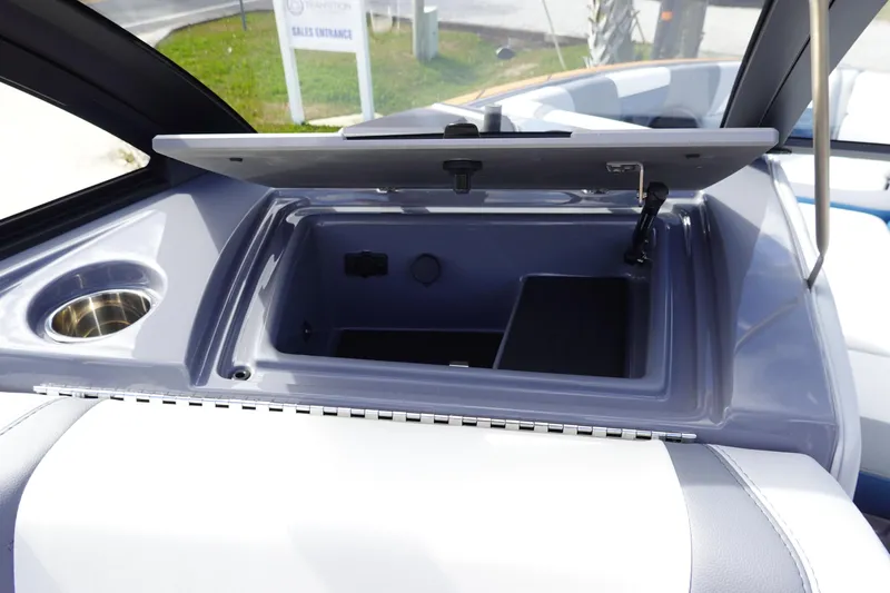 Slide: The Image of 2023 Malibu 25 LSV boat storage compartment with open lid. - 24