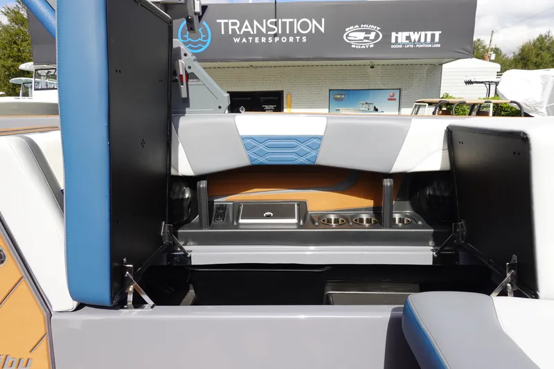 Slide: The Image of 2023 Malibu 25 LSV boat interior with seating and storage compartments. - 26