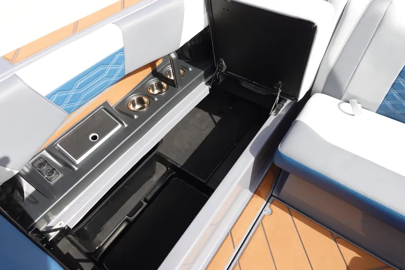 Slide: The Image of 2023 Malibu 25 LSV boat interior storage compartments and cup holders. - 27
