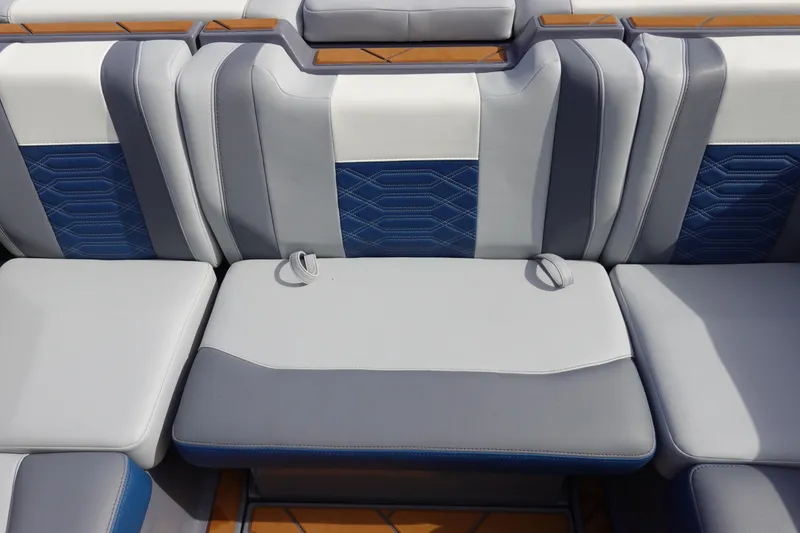 Slide: The Image of 2023 Malibu 25 LSV boat interior seating with blue and gray upholstery. - 28