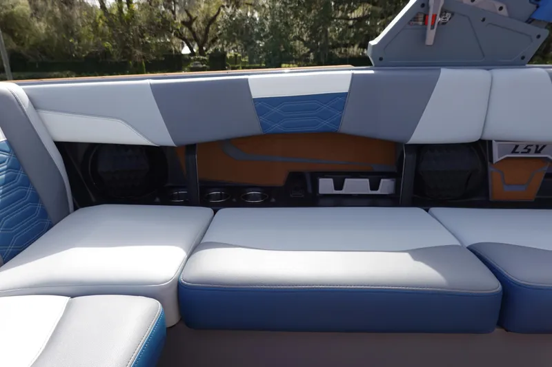 Slide: The Image of 2023 Malibu 25 LSV boat interior with blue and white seating. - 30
