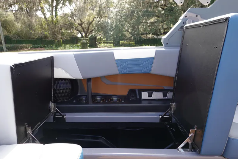 Slide: The Image of 2023 Malibu 25 LSV boat interior storage compartments open. - 31