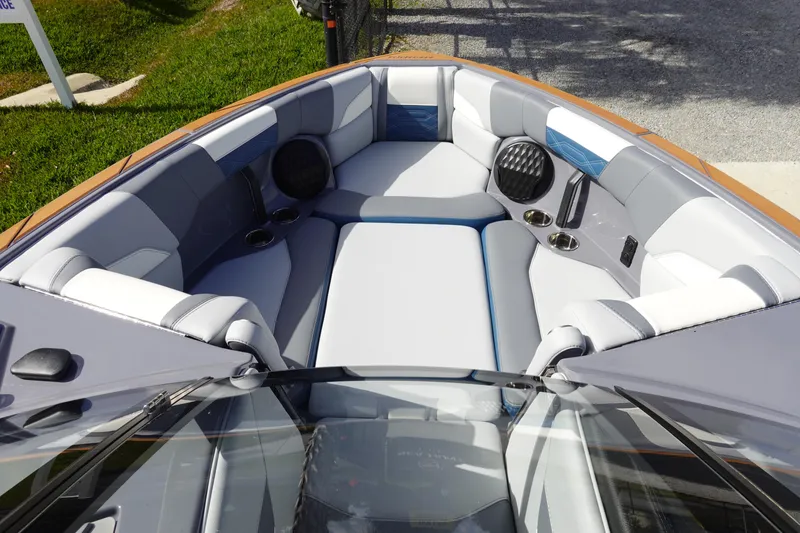 Slide: The Image of 2023 Malibu 25 LSV boat interior with cushioned seating and speakers. - 36
