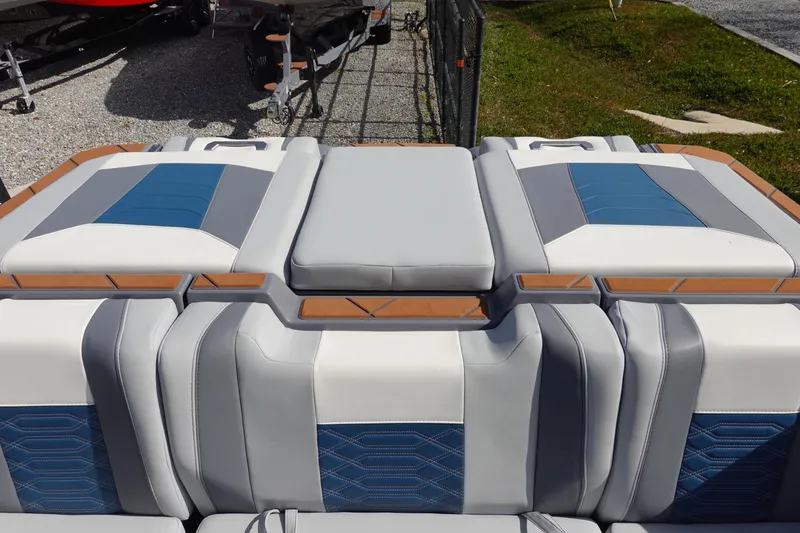 Slide: The Image of 2023 Malibu 25 LSV boat interior with blue and gray seating. - 41