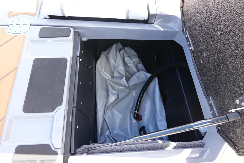 Slide: The Image of 2023 Malibu 25 LSV storage compartment with inflatable bag and hose. - 45