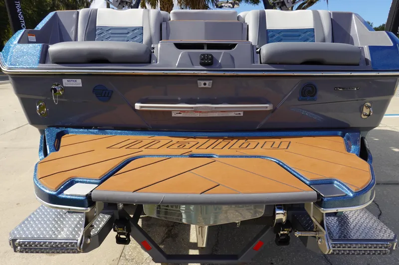 Slide: The Image of 2023 Malibu 25 LSV boat rear view with swim platform and seating. - 5