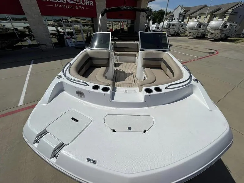 Slide: The Image of 2023 Hurricane SD187-IO boat with beige seating, displayed at a marine dealership. - 10