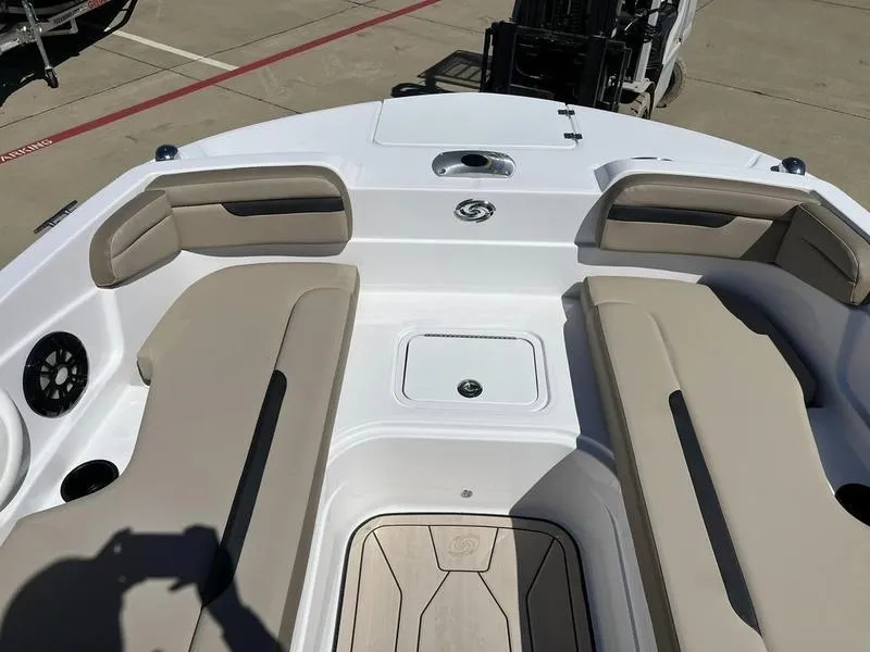 Slide: The Image of 2023 Hurricane SS205-OB boat interior with beige seating and storage compartments. - 10