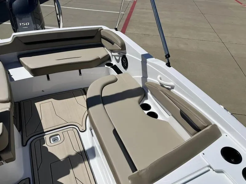 Slide: The Image of 2023 Hurricane SS205-OB boat interior with beige seating and cup holders. - 11