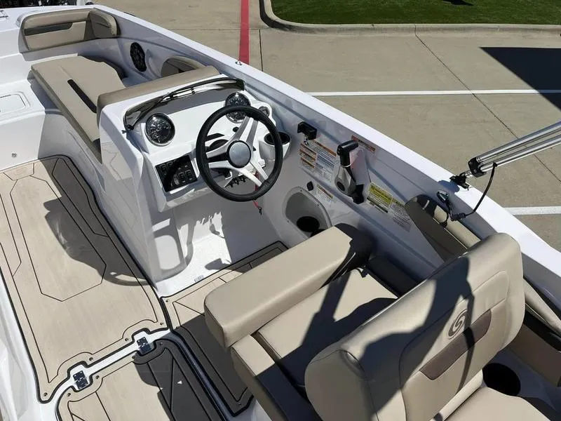 Slide: The Image of 2023 Hurricane SS205-OB boat interior with beige seating and modern dashboard. - 14