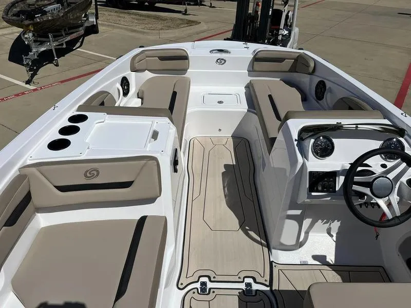 Slide: The Image of 2023 Hurricane SS205-OB boat interior with beige seating and modern dashboard. - 15