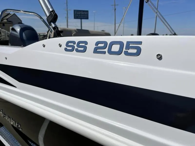 Slide: The Image of Close-up of 2023 Hurricane SS205-OB boat exterior with model name. - 7