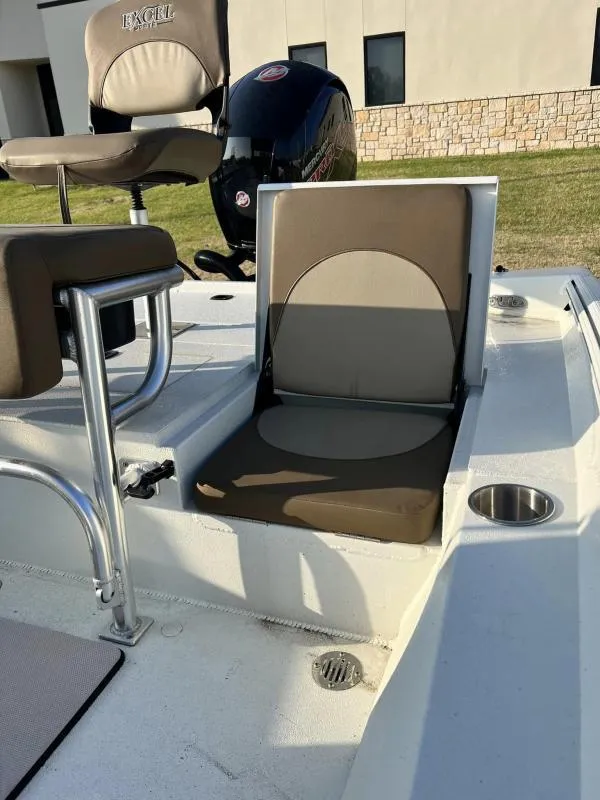 Slide: The Image of 2023 Excel Boats 203 Bay Pro interior seating and motor. - 10