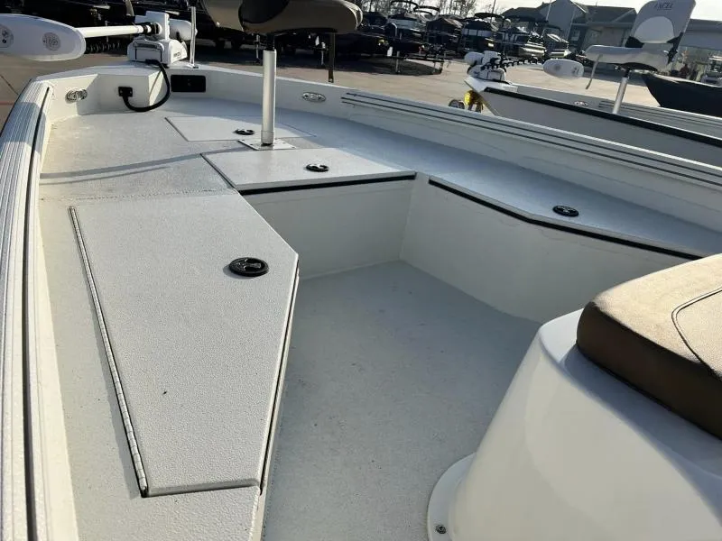 Slide: The Image of 2023 Excel Boats 203 Bay Pro interior with seating and storage compartments. - 11