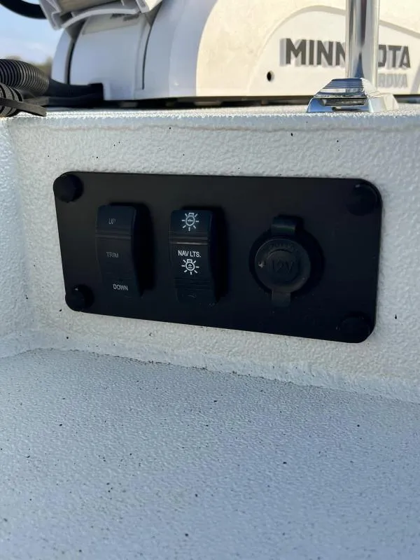 Slide: The Image of Control panel of 2023 Excel Boats 203 Bay Pro with trim and navigation light switches. - 18