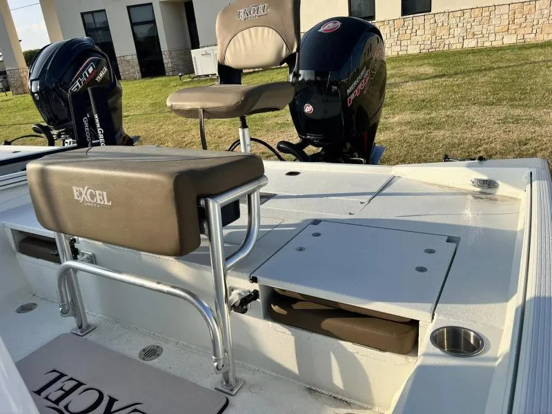 Slide: The Image of 2023 Excel Boats 203 Bay Pro interior with seating and storage compartments. - 7
