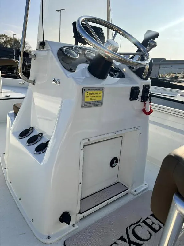 Slide: The Image of 2023 Excel Boats 203 Bay Pro console with steering wheel and controls. - 8