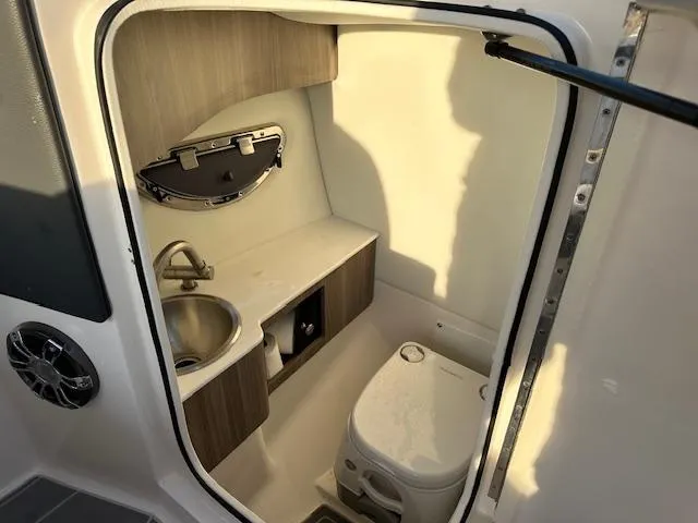 Slide: The Image of 2021 Regal LS6 boat interior bathroom with sink and toilet. - 10