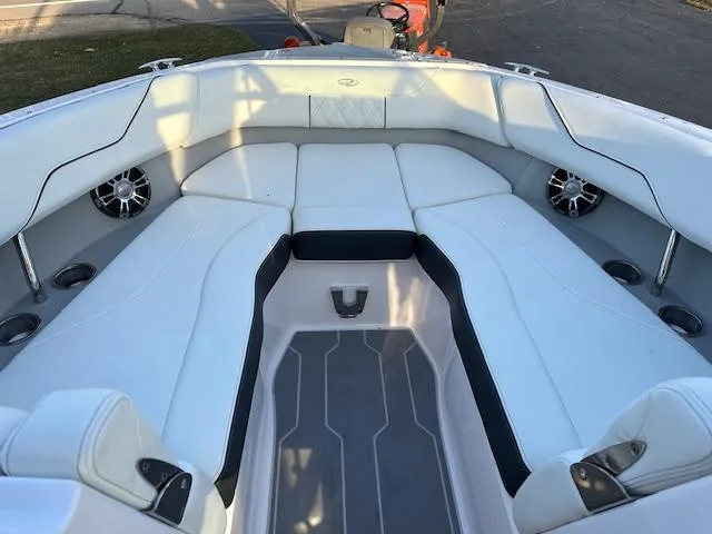 Slide: The Image of 2021 Regal LS6 boat interior with white cushioned seating and built-in speakers. - 11