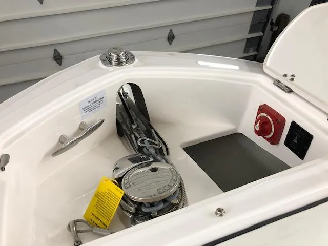 Slide: The Image of 2021 Regal LS6 boat anchor compartment with winch and control panel. - 13