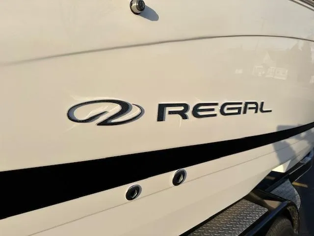 Slide: The Image of 2021 Regal LS6 boat side view with logo and sleek design. - 17