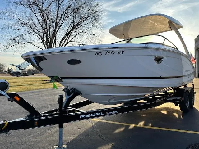 Slide: The Image of 2021 Regal LS6 boat on trailer, parked outdoors. - 18