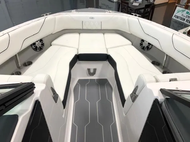 Slide: The Image of 2021 Regal LS6 boat interior with white cushioned seating and modern design. - 23