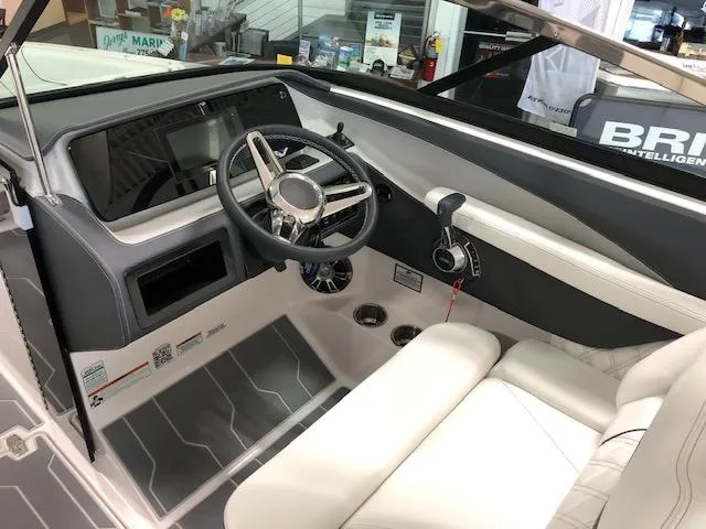 Slide: The Image of 2021 Regal LS6 boat interior with steering wheel and dashboard. - 24