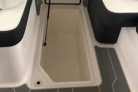 Slide: The Image of 2021 Regal LS6 boat storage compartment with cushioned seating. - 25