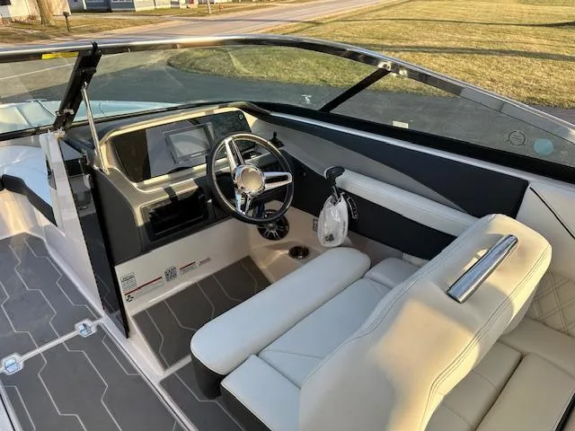 Slide: The Image of 2021 Regal LS6 boat interior with steering wheel and seating. - 5