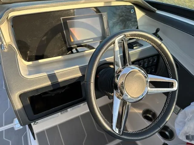 Slide: The Image of 2021 Regal LS6 boat dashboard with steering wheel and touchscreen display. - 6