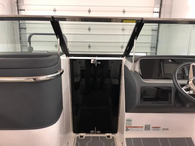 Slide: The Image of 2021 Regal LS6 boat interior with windshield and steering wheel. - 8