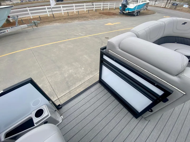 Slide: The Image of 2023 Starcraft SLS 3 pontoon boat with open gate and seating area. - 11