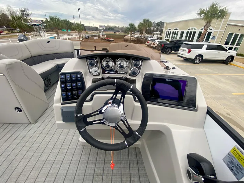 Slide: The Image of 2023 Starcraft SLS 3 boat dashboard with steering wheel and control panel. - 15