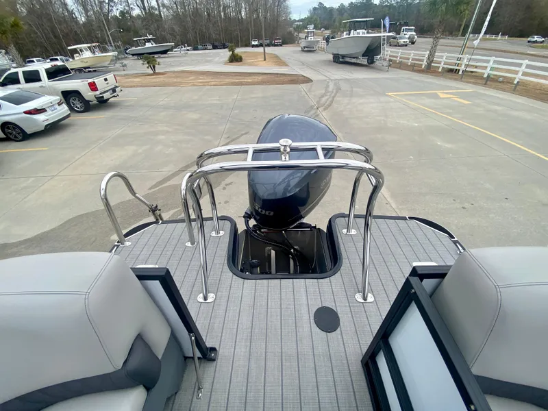 Slide: The Image of 2023 Starcraft SLS 3 boat with outboard motor in a parking lot. - 17