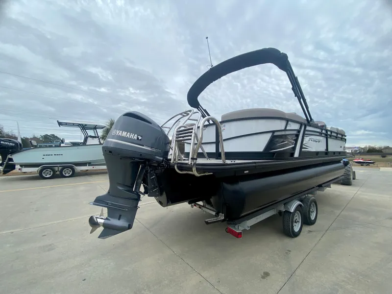 Slide: The Image of 2023 Starcraft SLS 3 pontoon boat with Yamaha outboard motor on trailer. - 2