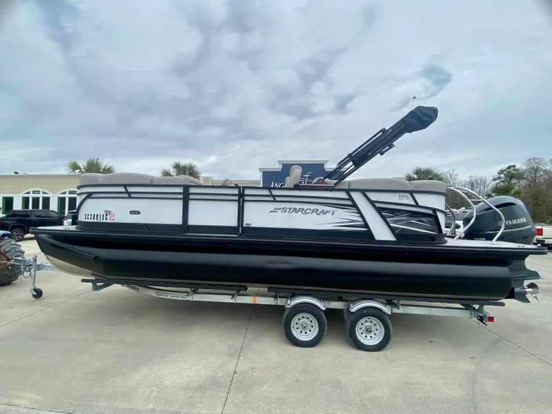 Slide: The Image of 2023 Starcraft SLS 3 pontoon boat on a trailer. - 4