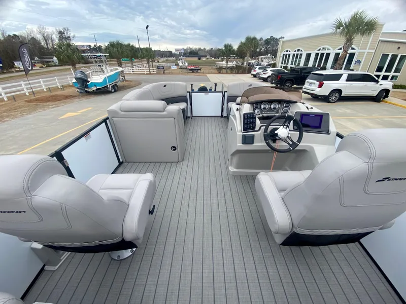 Slide: The Image of 2023 Starcraft SLS 3 pontoon boat interior with modern seating and control console. - 8