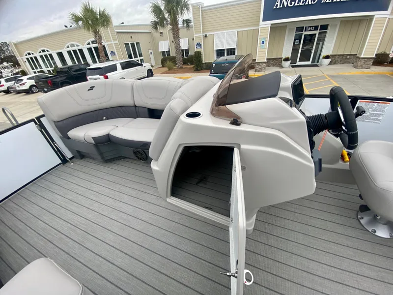 Slide: The Image of 2023 Starcraft SLS 3 pontoon boat interior with helm and seating area. - 16