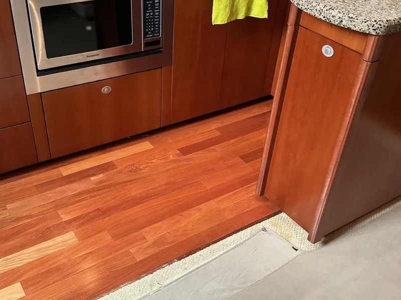 Slide: The Image of Interior of 2006 Sea Ray 48 Sundancer with wood flooring and modern cabinetry. - 11