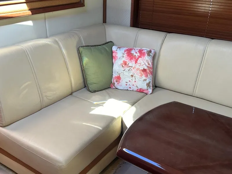 Slide: The Image of Interior of 2006 Sea Ray 48 Sundancer with beige seating and decorative pillows. - 12
