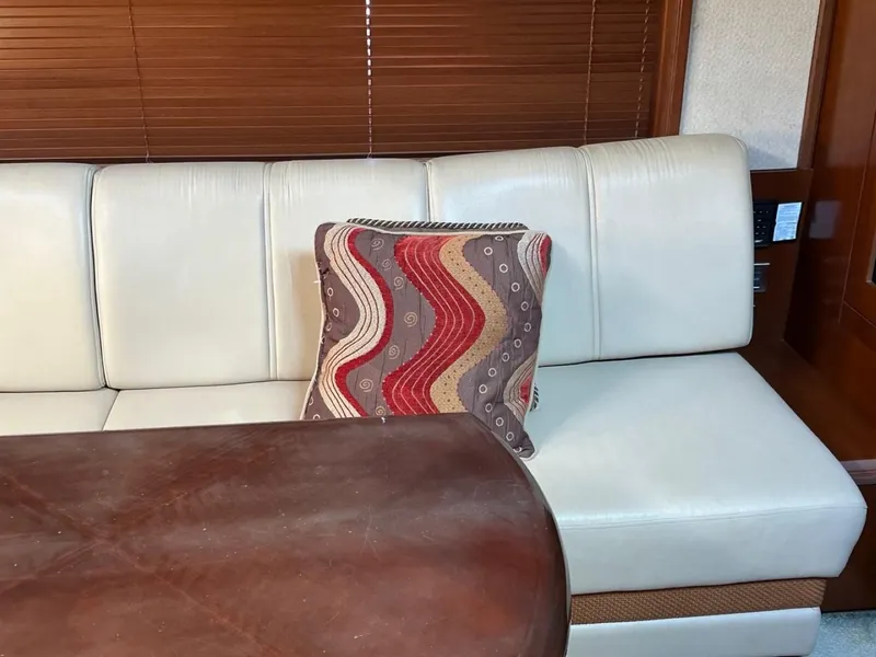 Slide: The Image of Luxurious interior of 2006 Sea Ray 48 Sundancer with white leather seating and decorative pillow. - 13