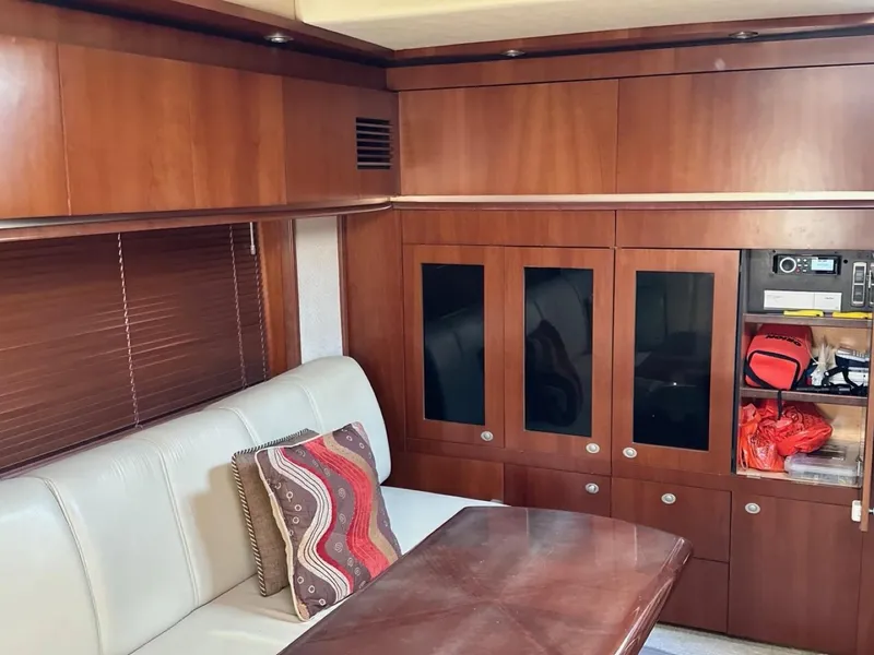 Slide: The Image of Interior of 2006 Sea Ray 48 Sundancer yacht with wood cabinets and beige seating. - 14