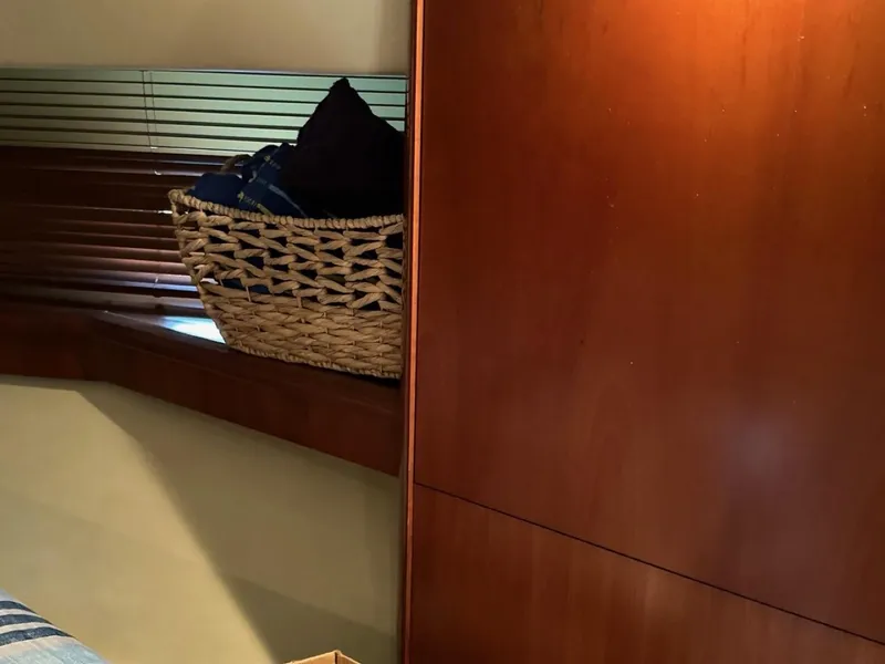 Slide: The Image of Interior of 2006 Sea Ray 48 Sundancer with wooden paneling and woven basket. - 18