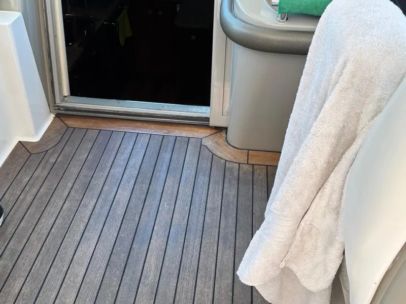 Slide: The Image of 2006 Sea Ray 48 Sundancer interior with wooden flooring and towel hanging. - 2