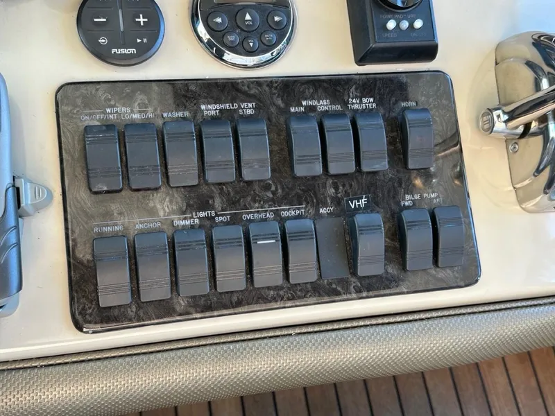 Slide: The Image of Control panel of a 2006 Sea Ray 48 Sundancer boat with various switches and dials. - 6