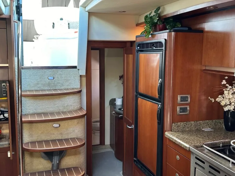 Slide: The Image of Interior of 2006 Sea Ray 48 Sundancer yacht with wooden cabinetry and stairs. - 7
