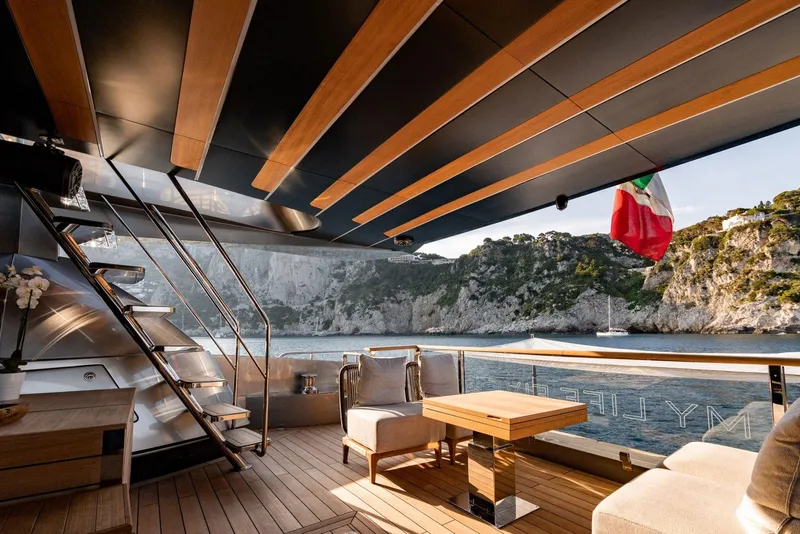 Slide: The Image of Luxurious deck of 2024 Posillipo Technema 90 yacht with scenic coastal view. - 13