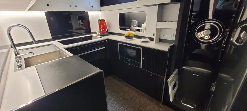 Slide: The Image of Modern kitchen in 2024 Posillipo Technema 90 yacht with sleek black and white design. - 15